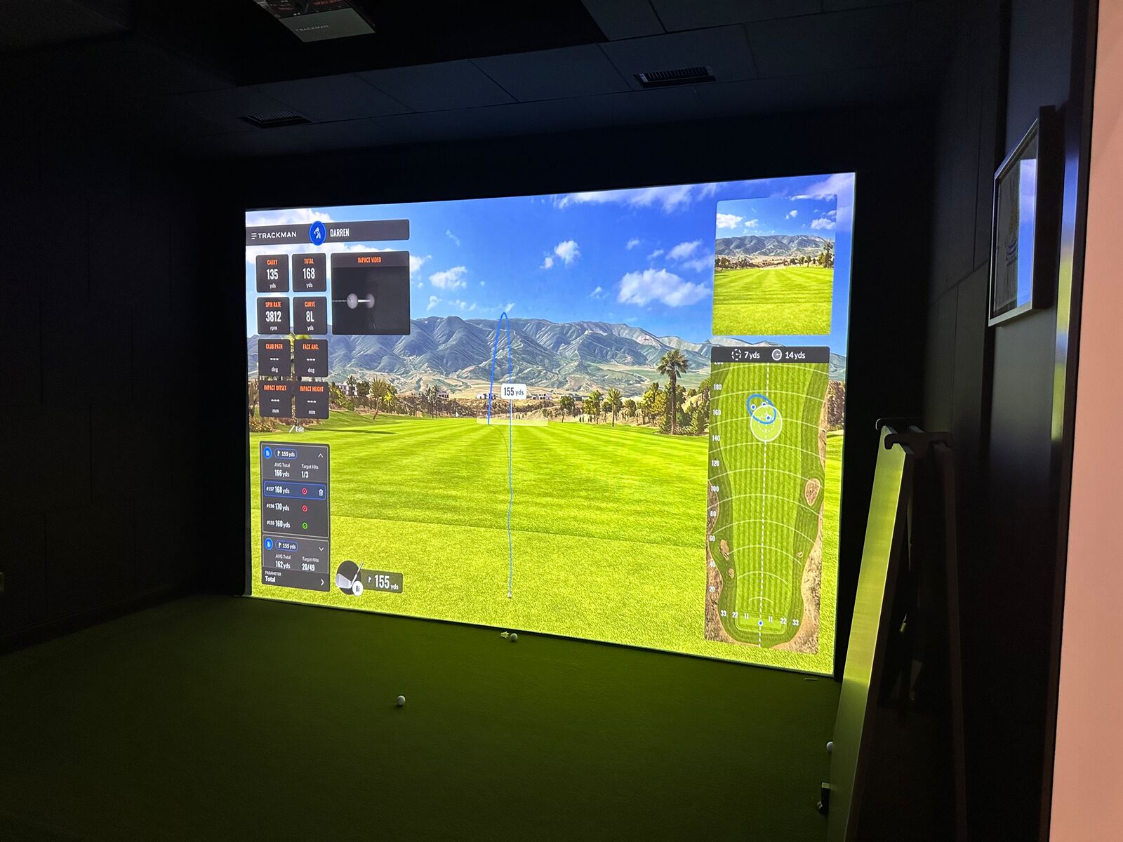 Golf simulator bay with a large projected course